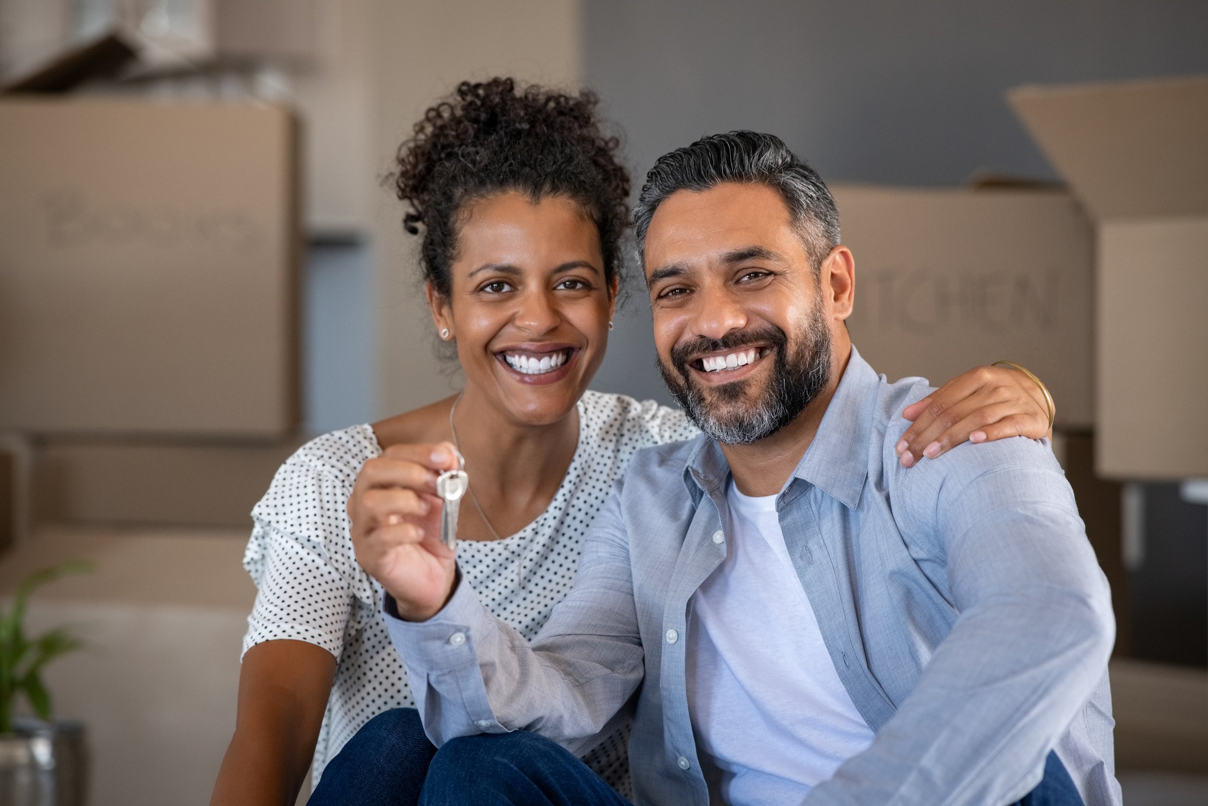 Mixed race couple holding new house keys